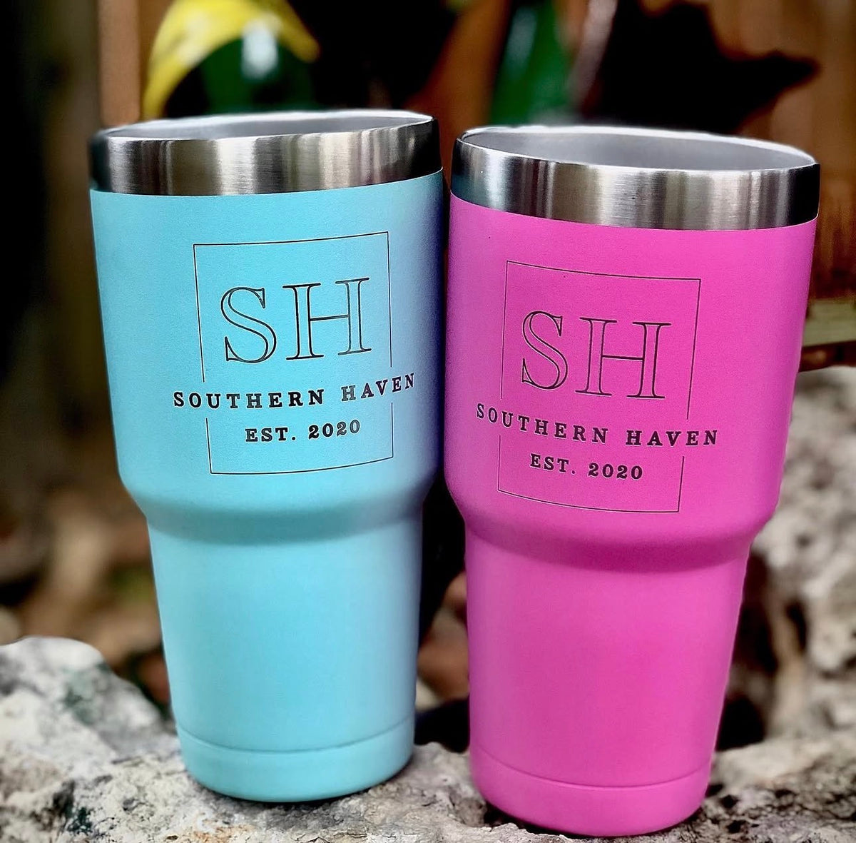 Blue and pink tumblers with Southern Haven logo engraved