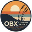 Logo of OBX Custom Works with a sunset design and text about promotional goods and apparel.